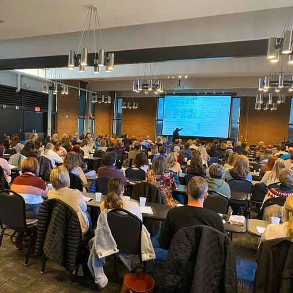 People watching a screen sitting in a conference