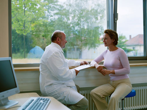 Doctor and paitent having conversation near window at United Smile Centres, Louisville, KY