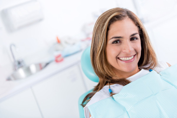 A woman with mini dental implants smiling at United Smile Centres in Louisville, KY